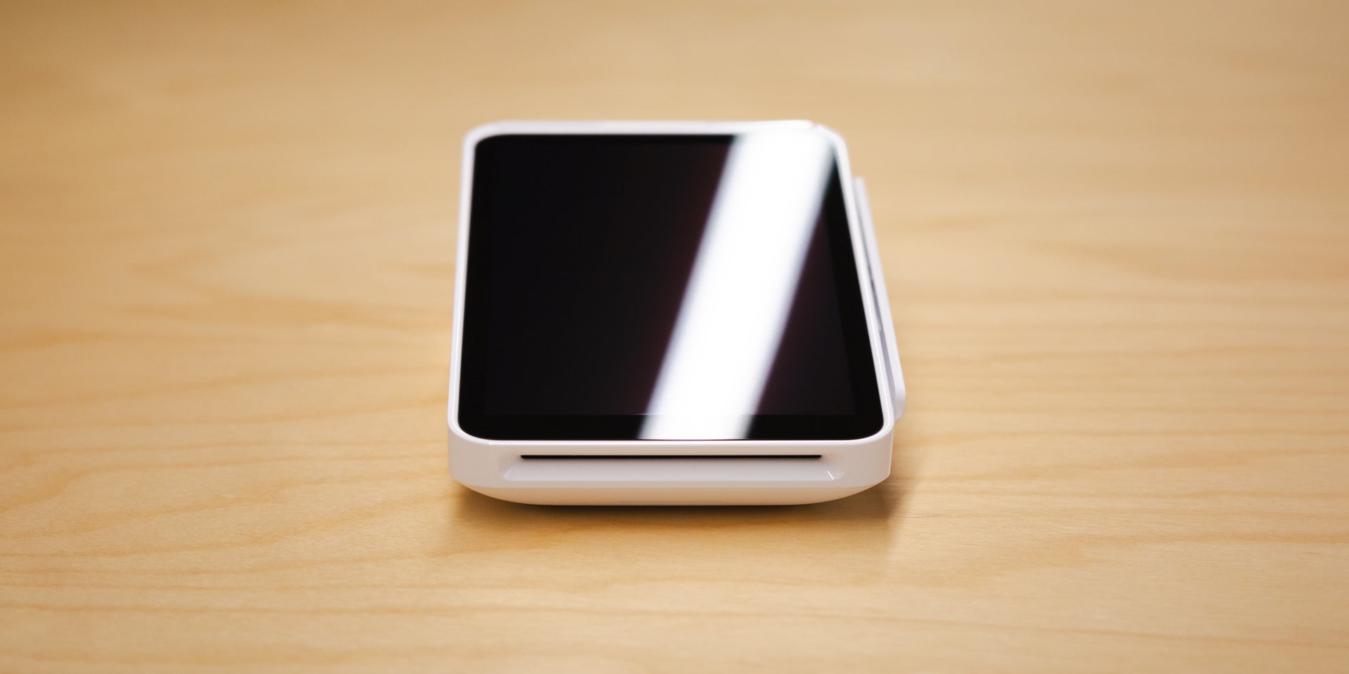 Close-up of Square POS card reader on table. Source: Tech.co