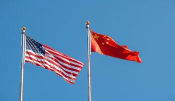 US and Chinese flags blowing in the wind