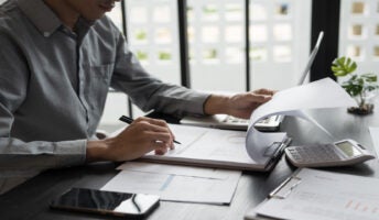 Person sitting at desk doing accounting