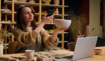 Woman taking picture of vase on phone