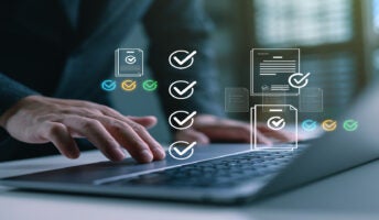 Person working on laptop with project management software on screen