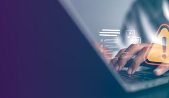 Person typing on laptop experiencing cybersecurity breach