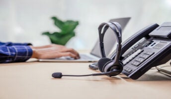 VoIP deskphone with headset on desk