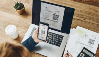 Person scanning QR code on invoice