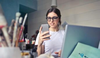 Person with a laptop and a phone