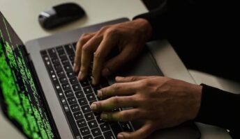 Typing code on a laptop