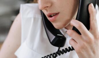 A worker placing two phone calls